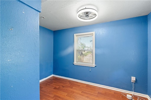 2803 Harrison St, Kansas City, MO 64109 - empty room with wood finished floors and baseboards