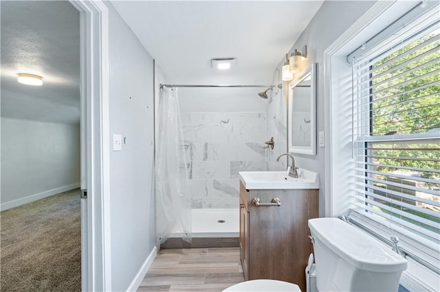2803 Harrison St, Kansas City, MO 64109 - bathroom featuring toilet, a shower stall, vanity, and healthy amount of natural light