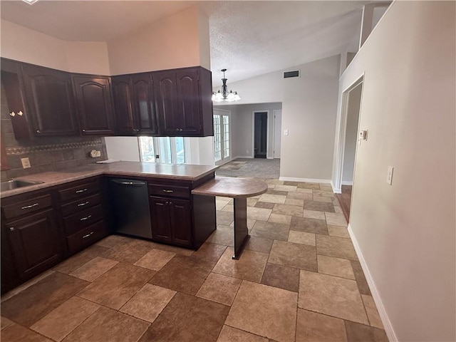 kitchen featuring dishwashing machine, visible vents, baseboards, backsplash, and lofted ceiling