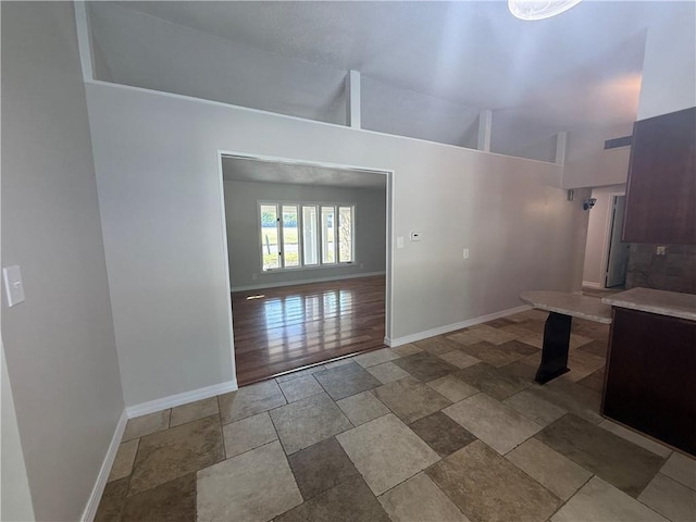 interior space featuring visible vents, baseboards, and stone finish floor