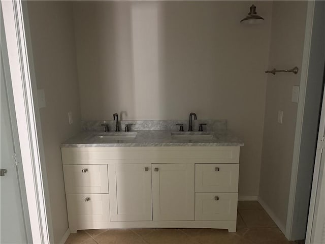 bathroom with double vanity, tile patterned floors, and a sink