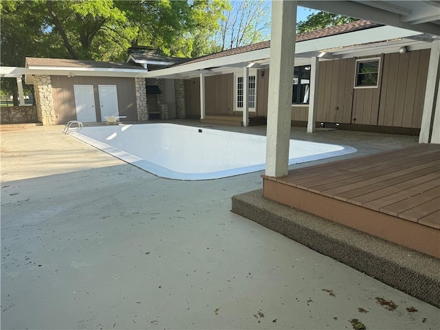 view of pool featuring a patio area, an empty pool, and french doors