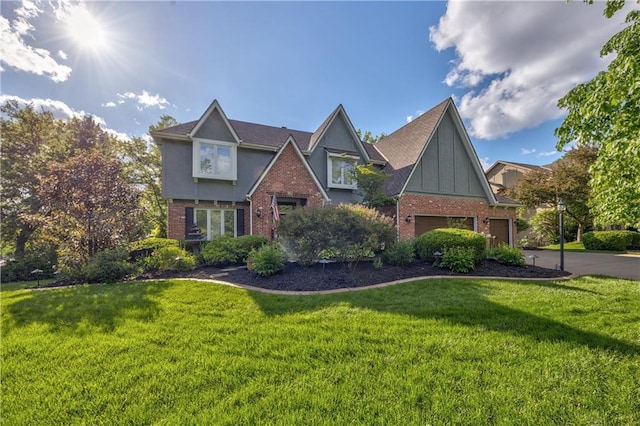 8618 W 138th Ter, Overland Park, KS 66223 - tudor home with brick siding, a front lawn, driveway, and stucco siding
