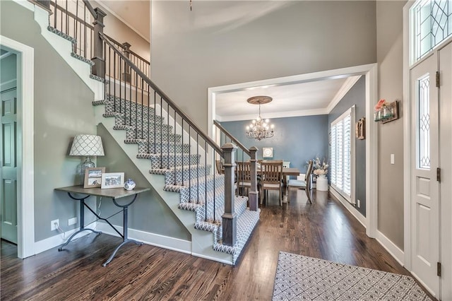 8618 W 138th Ter, Overland Park, KS 66223 - foyer with ornamental molding, wood finished floors, baseboards, a chandelier, and stairs
