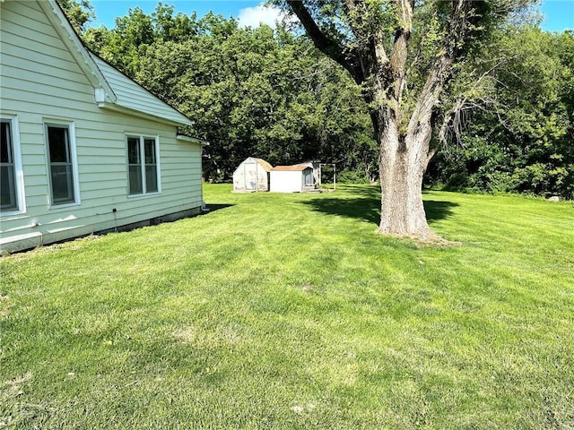 509 Whitcomb St, Lathrop, MO 64465 - view of green lawn featuring a shed