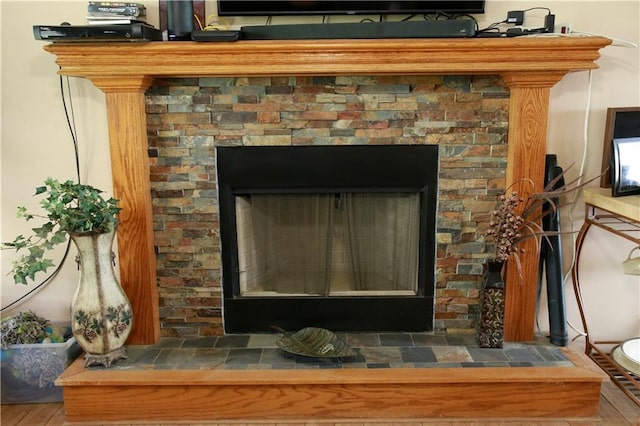 29208 E 343rd St, Garden City, MO 64747 - details featuring a fireplace with raised hearth and wood finished floors