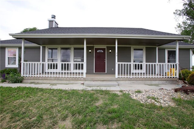 29208 E 343rd St, Garden City, MO 64747 - view of front of home featuring a chimney and covered porch