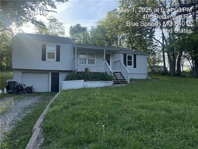 405 S Bellemere Rd, Blue Springs, MO 64015 - view of front facade with a porch, a front yard, a garage, and driveway