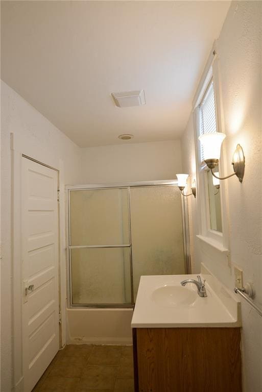 1221 Morgan Ave, Parsons, KS 67357 - full bath with enclosed tub / shower combo, vanity, and visible vents