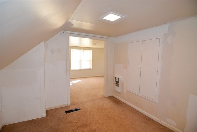 1221 Morgan Ave, Parsons, KS 67357 - additional living space with light colored carpet, visible vents, lofted ceiling, and heating unit