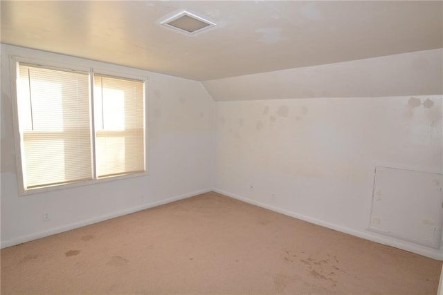 1221 Morgan Ave, Parsons, KS 67357 - additional living space with light colored carpet, baseboards, and lofted ceiling