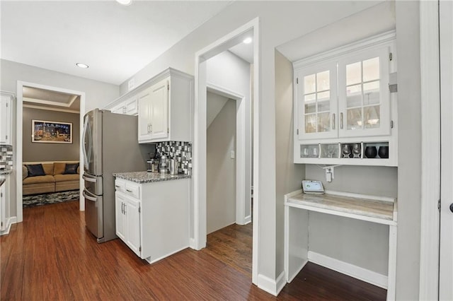 kitchen with white cabinets, freestanding refrigerator, dark wood-style floors, light stone counters, and recessed lighting