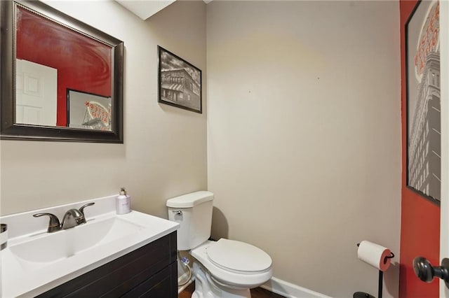 half bath featuring toilet and vanity