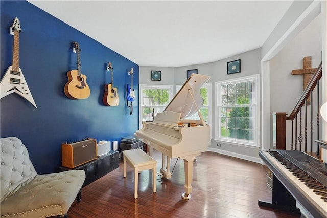 sitting room featuring wood finished floors, stairs, and baseboards