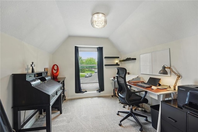 carpeted office space featuring lofted ceiling and baseboards