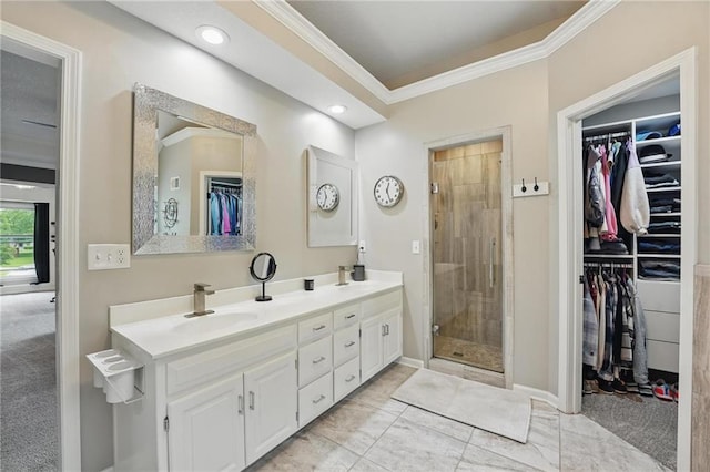 bathroom with ornamental molding, a shower stall, a spacious closet, double vanity, and recessed lighting