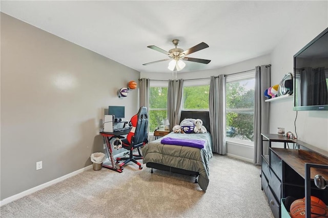 bedroom with multiple windows, carpet floors, baseboards, and a ceiling fan