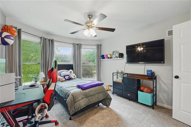 carpeted bedroom with a desk, a ceiling fan, and baseboards