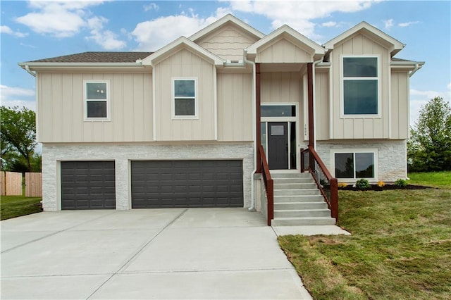 1604 Mulberry St, Pleasant Hill, MO 64080 - split foyer home with concrete driveway, an attached garage, and board and batten siding