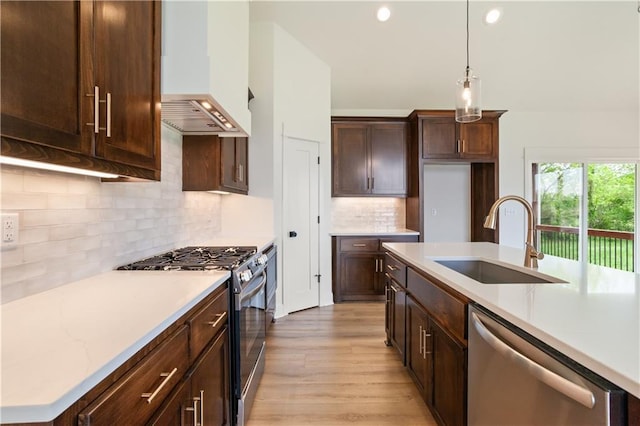 1604 Mulberry St, Pleasant Hill, MO 64080 - kitchen with appliances with stainless steel finishes, a sink, light wood-style flooring, custom range hood, and dark brown cabinetry