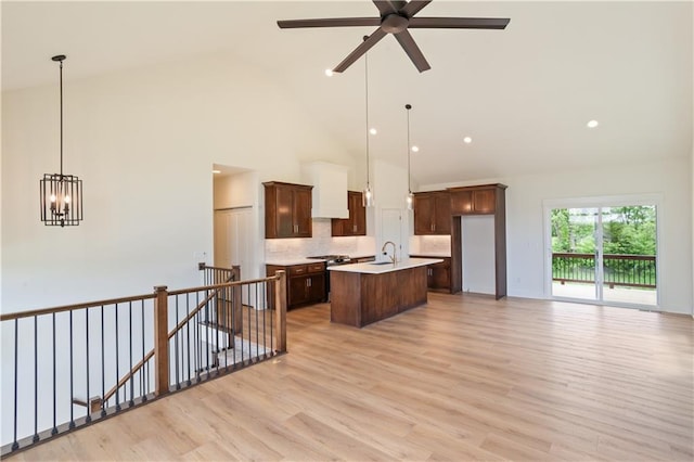 1604 Mulberry St, Pleasant Hill, MO 64080 - kitchen with high vaulted ceiling, tasteful backsplash, a kitchen island with sink, light countertops, and a ceiling fan