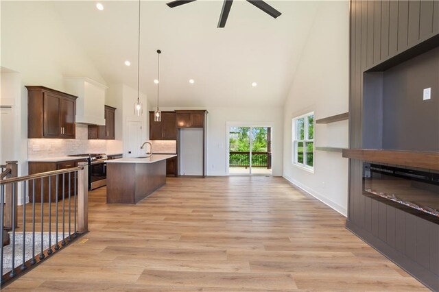 1604 Mulberry St, Pleasant Hill, MO 64080 - kitchen featuring stainless steel range with gas cooktop, high vaulted ceiling, a sink, open floor plan, and a ceiling fan