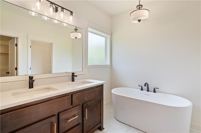 1604 Mulberry St, Pleasant Hill, MO 64080 - bathroom featuring a freestanding tub, double vanity, and baseboards