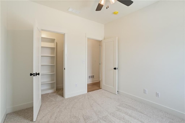 1604 Mulberry St, Pleasant Hill, MO 64080 - unfurnished bedroom featuring a walk in closet, carpet, baseboards, and a ceiling fan
