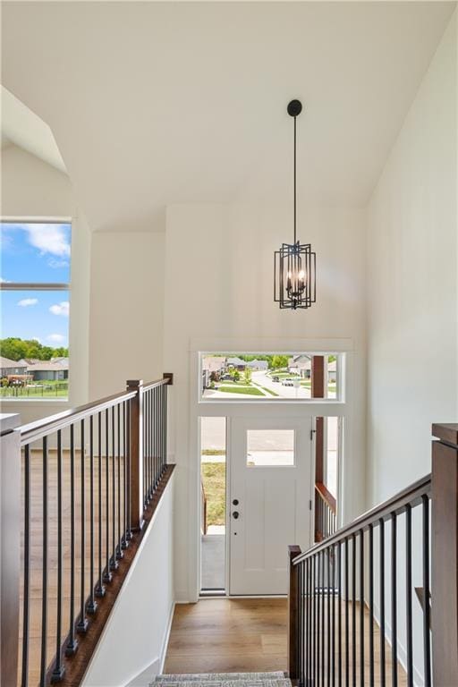 1604 Mulberry St, Pleasant Hill, MO 64080 - entrance foyer with a chandelier, wood finished floors, healthy amount of natural light, and baseboards