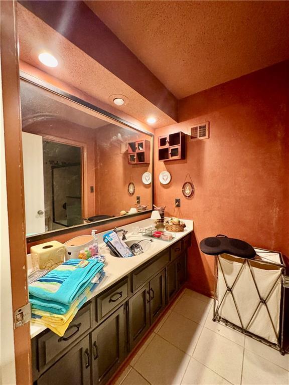 5212 Somerset Dr, Prairie Village, KS 66207 - bathroom featuring a textured ceiling, tile patterned floors, vanity, and recessed lighting