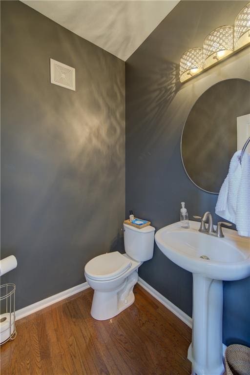 8812 NE 101st St, Kansas City, MO 64157 - half bath with wood finished floors, baseboards, toilet, and a sink