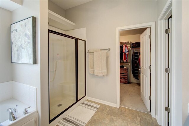 8812 NE 101st St, Kansas City, MO 64157 - full bathroom featuring a shower stall, a walk in closet, and a garden tub