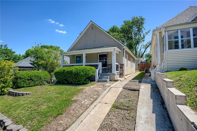 217 N Valley St, Kansas City, KS 66102 - bungalow featuring covered porch and stone siding