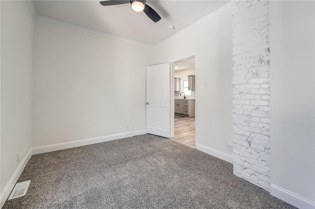 217 N Valley St, Kansas City, KS 66102 - unfurnished bedroom with carpet floors, crown molding, baseboards, and ceiling fan
