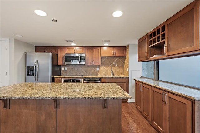 kitchen with stainless steel appliances, a sink, open shelves, dark wood-type flooring, and backsplash