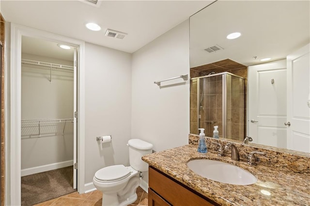 full bathroom with a stall shower, toilet, vanity, recessed lighting, and tile patterned floors
