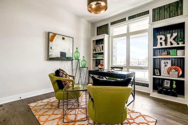 living area with wood finished floors and baseboards