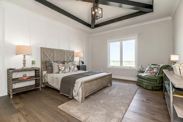 bedroom featuring a tray ceiling, crown molding, wood finished floors, and baseboards