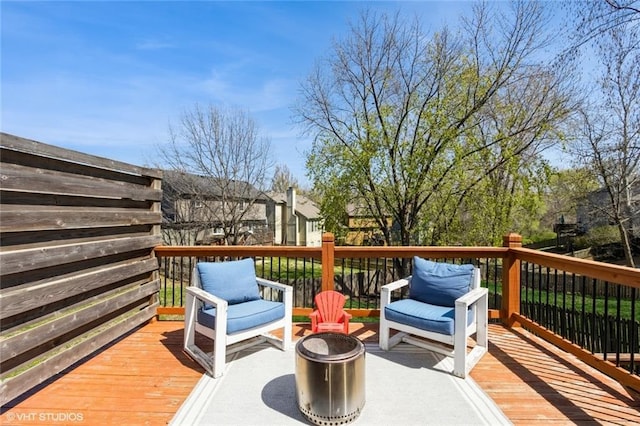 wooden terrace featuring a fire pit