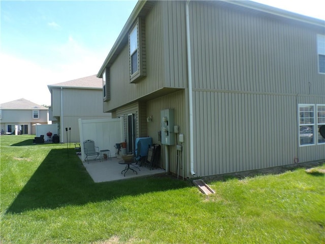 back of property featuring a patio and a lawn