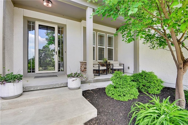 24411 W 70th St, Shawnee, KS 66226 - view of exterior entry featuring covered porch and stucco siding