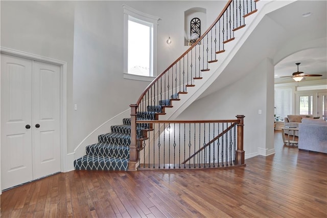 24411 W 70th St, Shawnee, KS 66226 - stairs with ceiling fan, hardwood / wood-style floors, baseboards, and a high ceiling