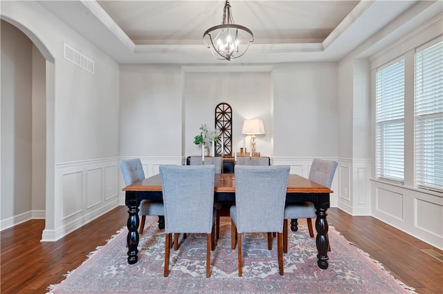 24411 W 70th St, Shawnee, KS 66226 - dining area with a tray ceiling, plenty of natural light, wood-type flooring, a chandelier, and a decorative wall