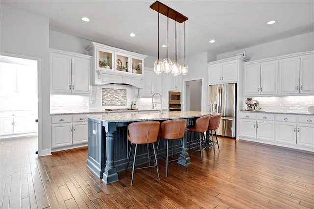 24411 W 70th St, Shawnee, KS 66226 - kitchen featuring stainless steel appliances, a sink, backsplash, white cabinetry, and recessed lighting
