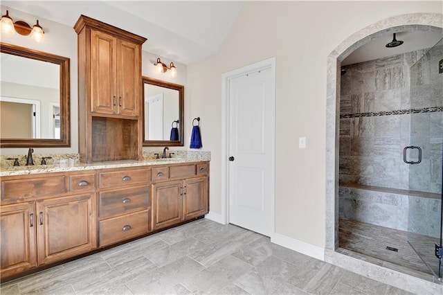 24411 W 70th St, Shawnee, KS 66226 - full bath with a stall shower, vaulted ceiling, baseboards, and double vanity