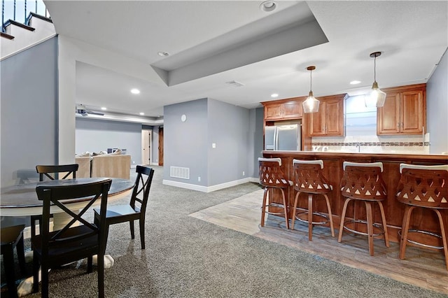 24411 W 70th St, Shawnee, KS 66226 - kitchen featuring stainless steel fridge, a breakfast bar area, recessed lighting, tasteful backsplash, and hanging light fixtures
