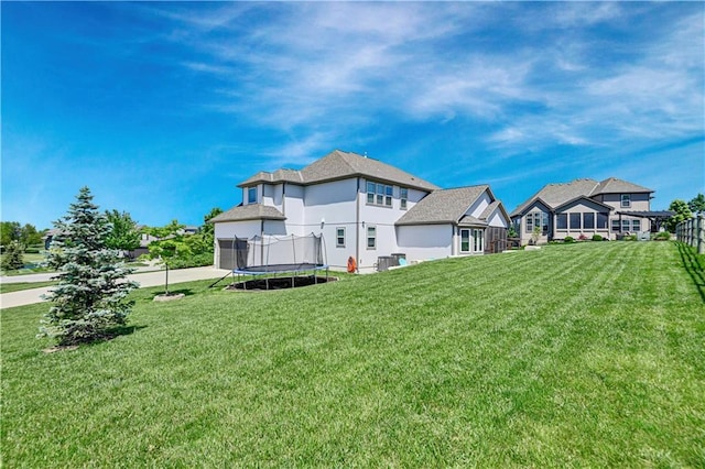 24411 W 70th St, Shawnee, KS 66226 - back of house with a trampoline and a lawn
