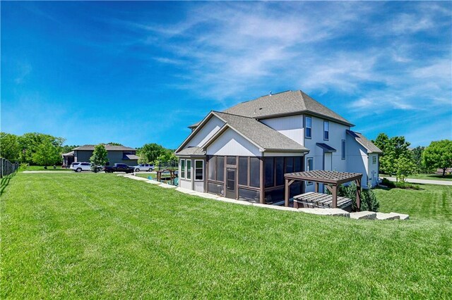 24411 W 70th St, Shawnee, KS 66226 - back of house with a sunroom, a lawn, and roof with shingles