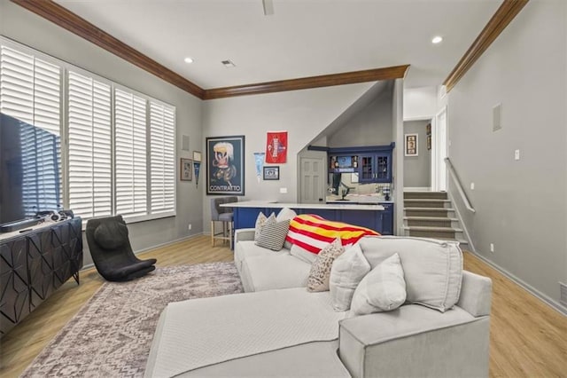 living area with crown molding, light wood-style flooring, baseboards, recessed lighting, and stairs