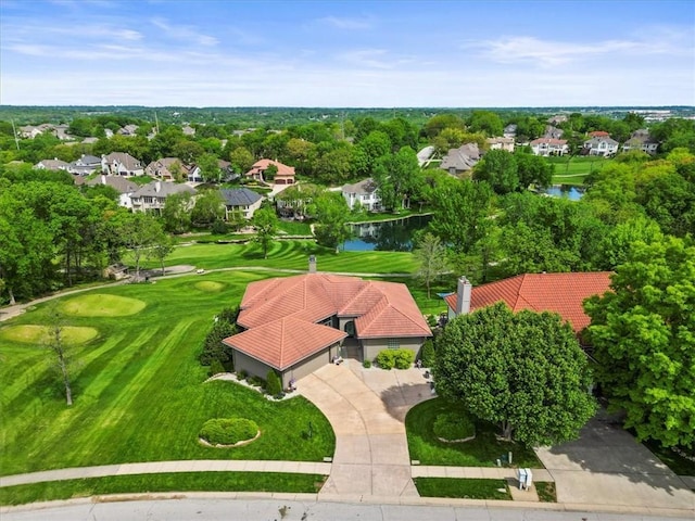 aerial perspective of suburban area with a golf course and a large body of water